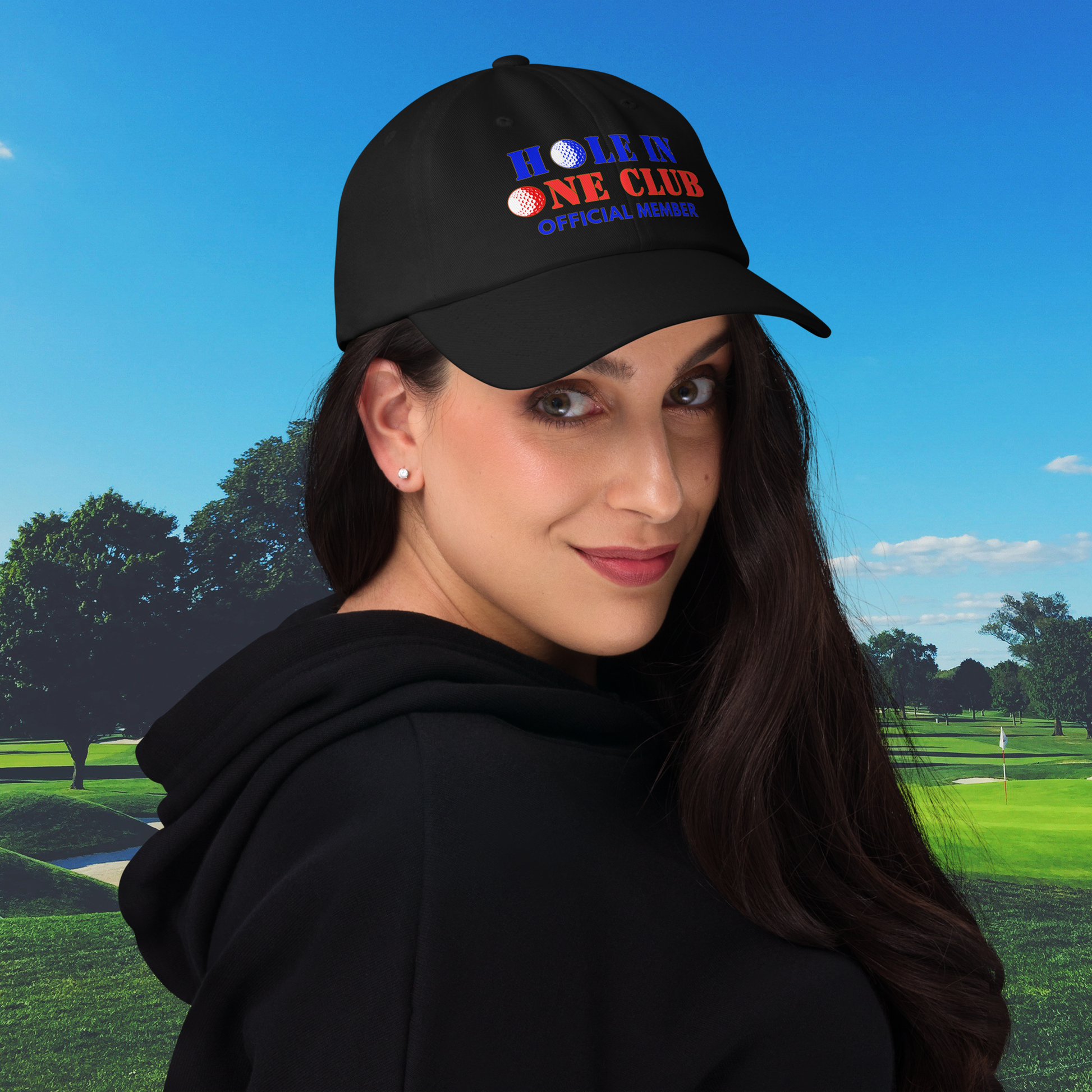 Woman wearing a black cap with 'Hole in One Club' text on a golf course background