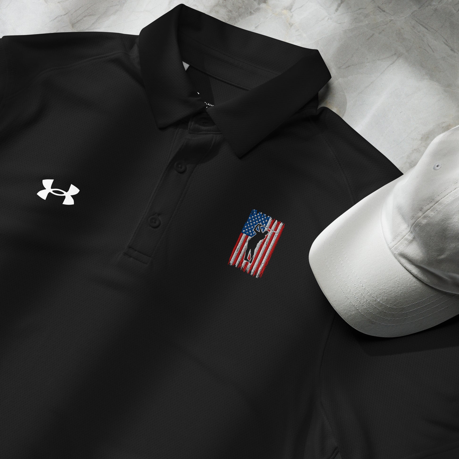 Black patriotic golf polo with Under Armour logo displayed