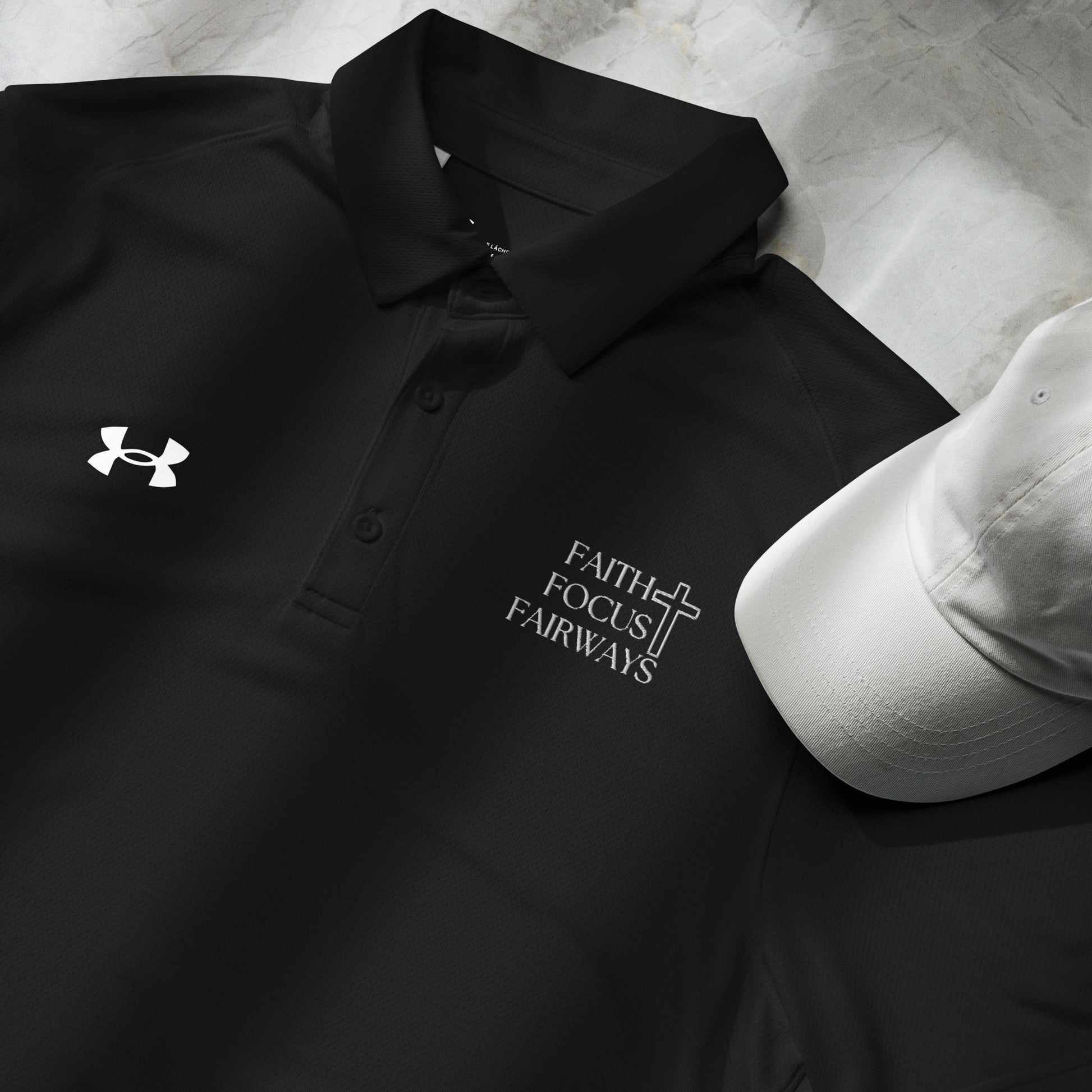Folded black golf shirt with subtle Christian-inspired embroidery