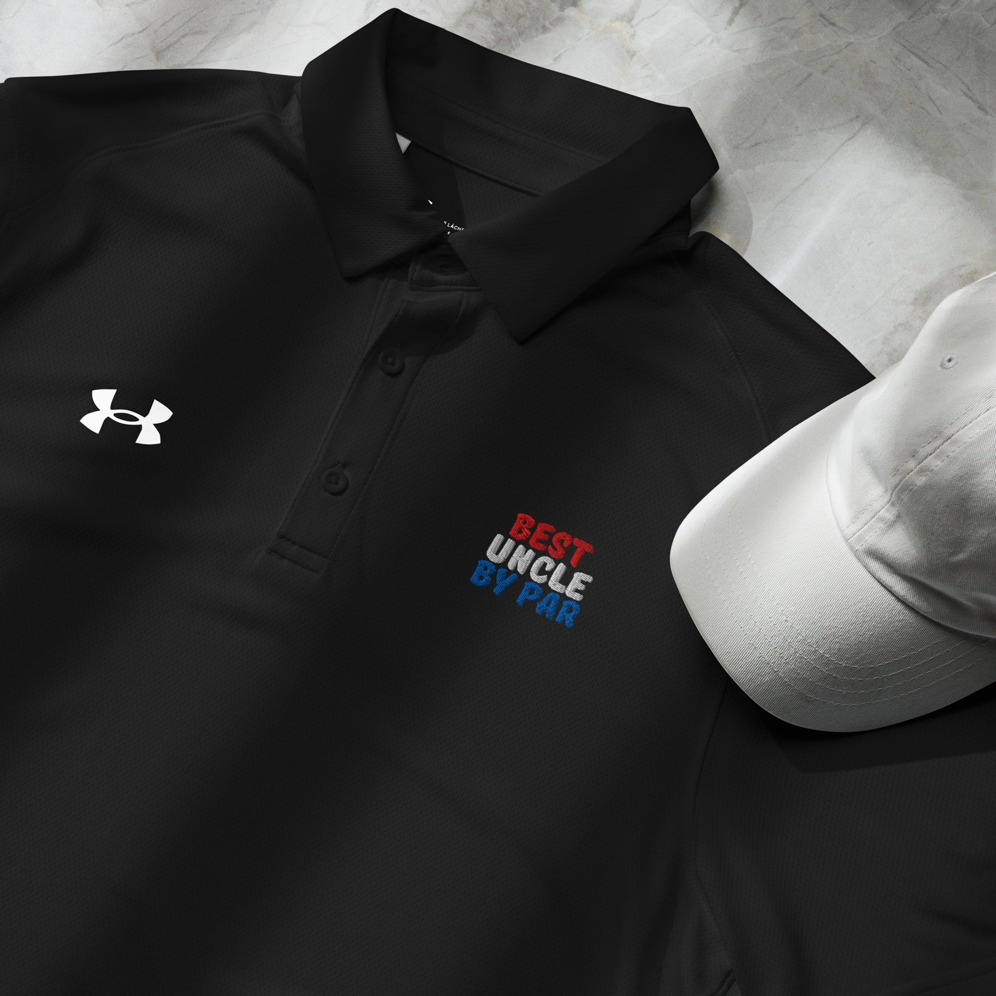 folded black golf polo with red white and blue uncle design