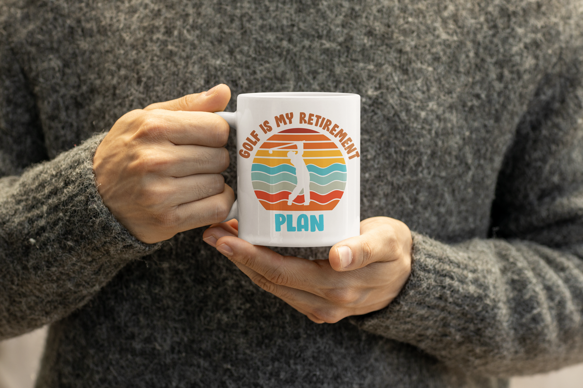 Coffee mug featuring golfer swinging in front of sunset-style art