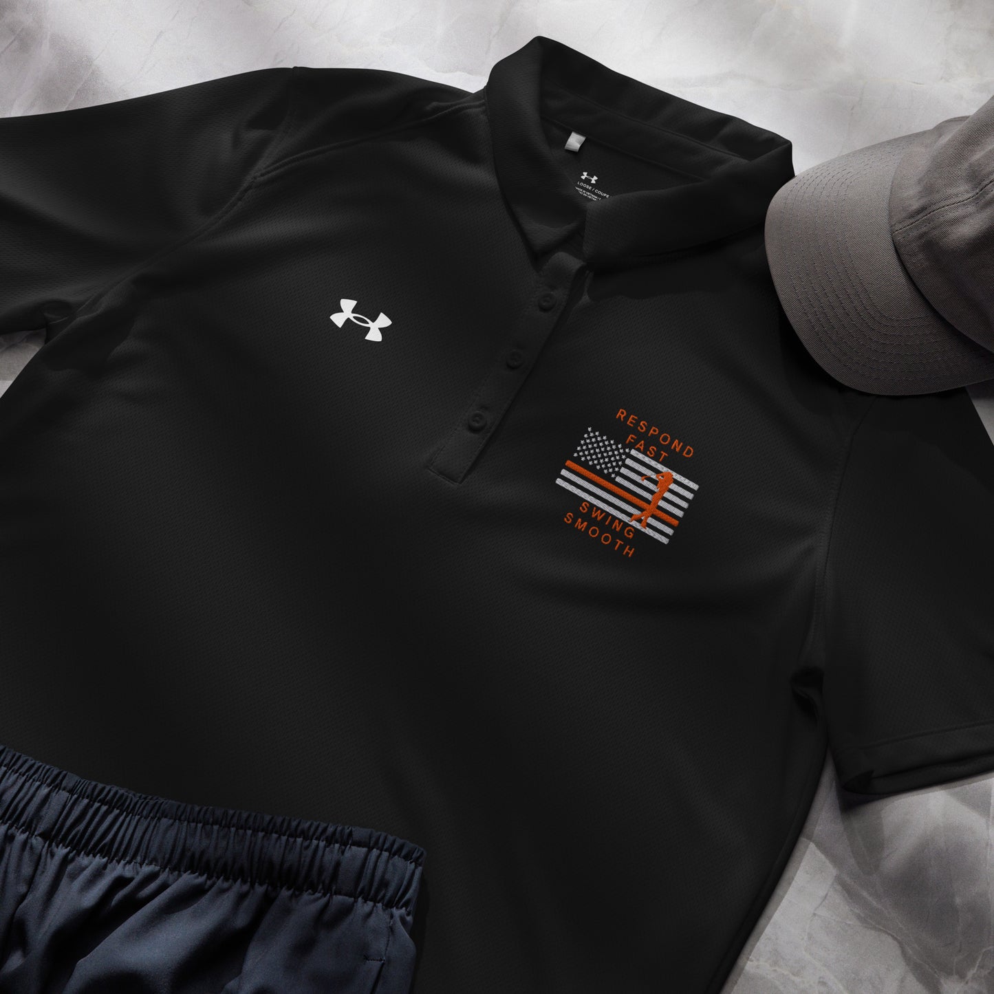 Black women's Under Armour golf polo with Respond Fast Swing Smooth thin orange line design