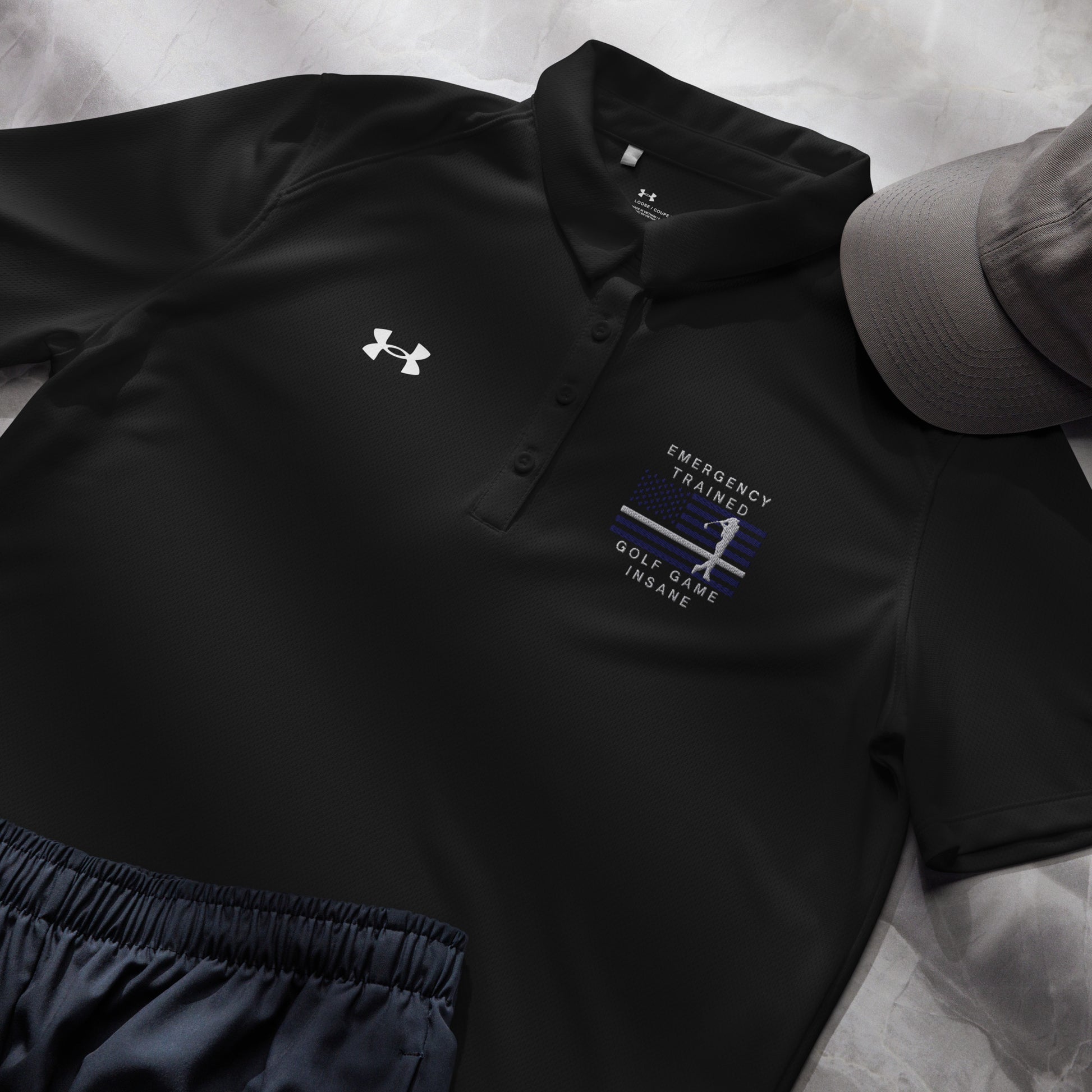 Black Under Armour ladies polo with emergency medical inspired golfer flag design