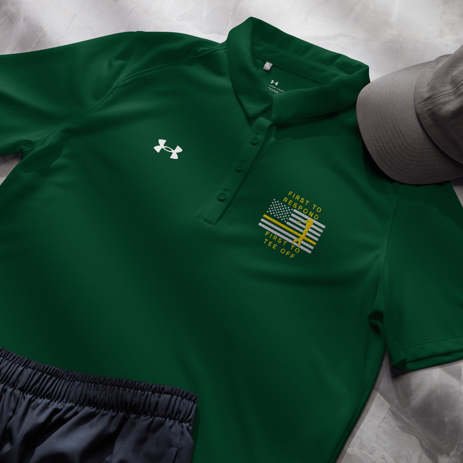 Forest green women's Under Armour golf polo with First To Respond First To Tee Off design