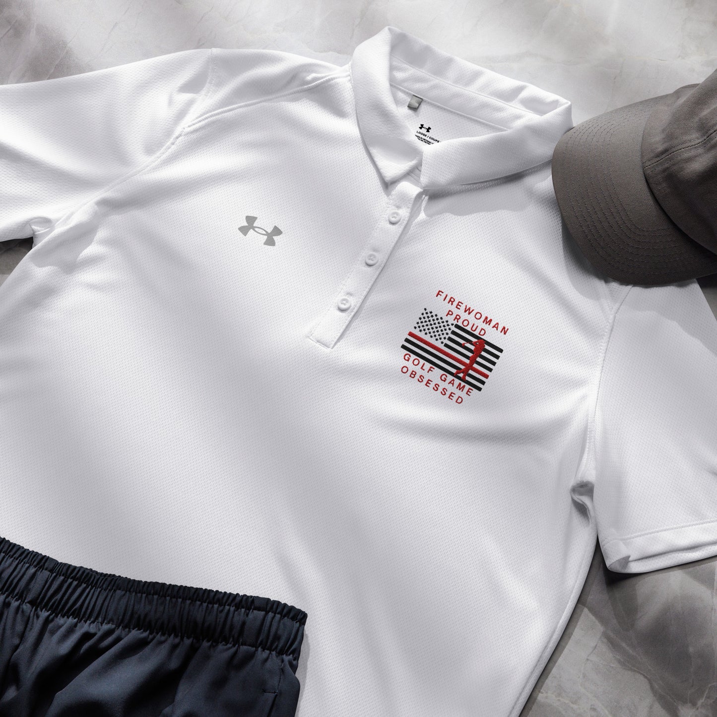 White ladies fire department golf shirt with red golfer silhouette and flag graphic